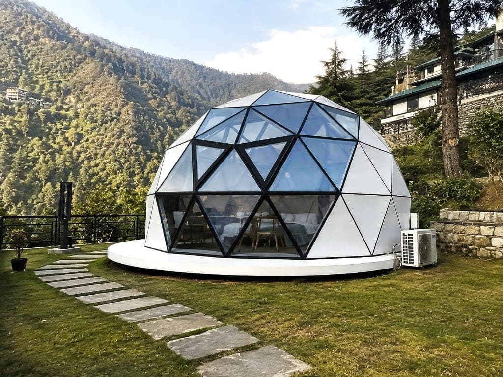 NIVA D2 grounded luxury dome cabin on lawn with stone path